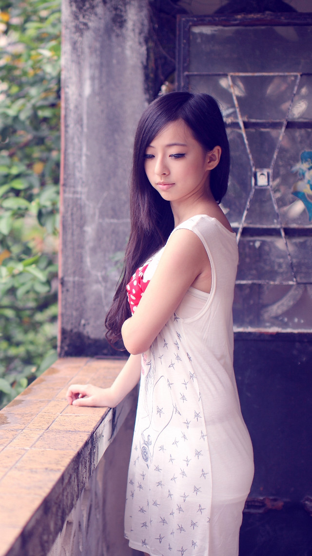 Woman standing ledged serious look free wallpaper - medium preview image