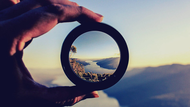 Person holding mirror mountain background free wallpaper - medium preview image