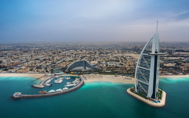 Tall building beach water boats free wallpaper - medium preview image