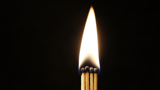 Matchstick lit dark flame between free wallpaper - medium preview image