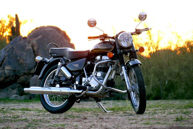 Motorcycle parked field rock sunset free wallpaper - medium preview image