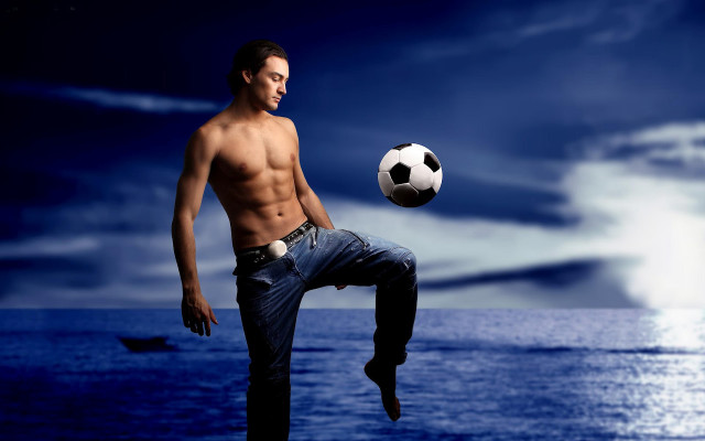 Man kicking soccer ball ocean free wallpaper - medium preview image