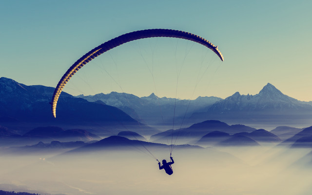 Parasailing mountains foggy sky ocean free wallpaper - medium preview image