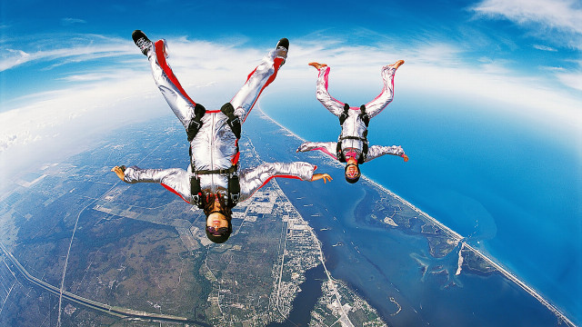 Skydiving white suits arms out free wallpaper - medium preview image