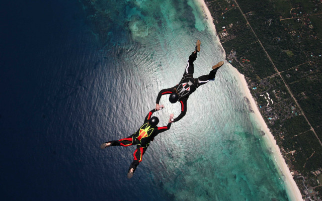Parachute flying ocean city background free wallpaper - medium preview image
