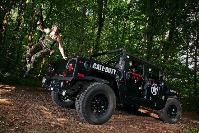 Man jumping jeep woods foreground free wallpaper - medium preview image