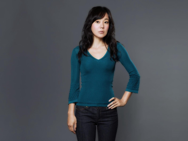 Woman green shirt posing hands #2 free wallpaper - medium preview image