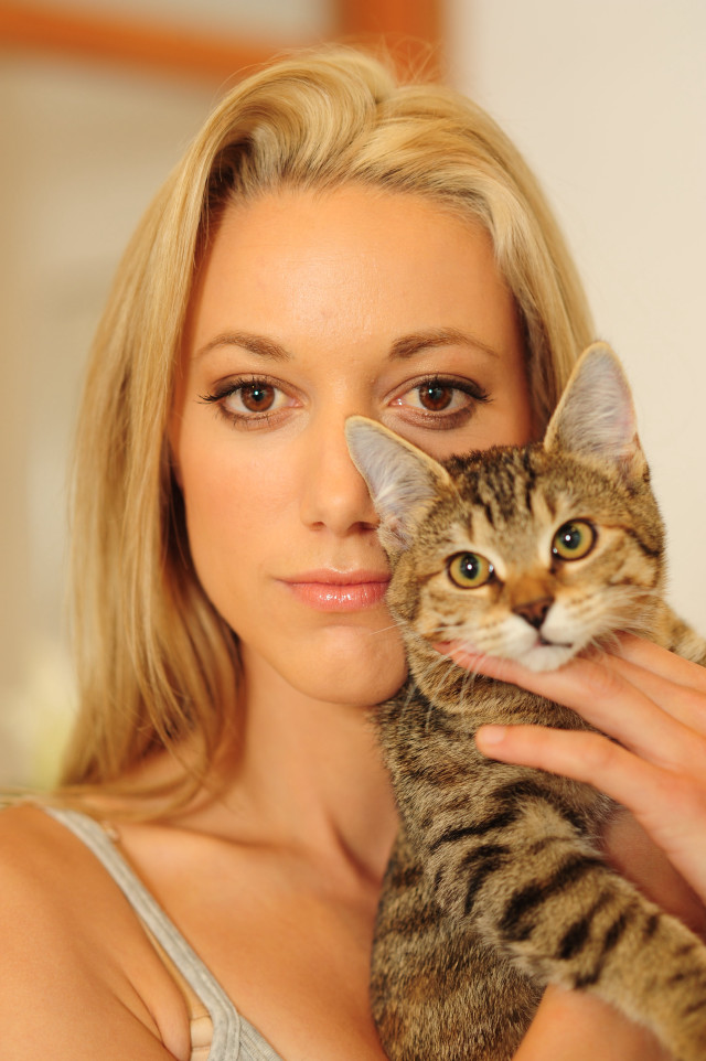 Woman holding cat serious look #2 free wallpaper - medium preview image