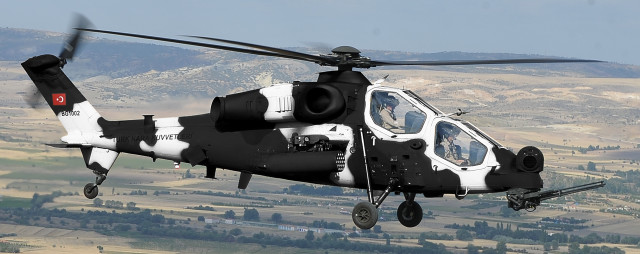 Helicopter flying lush green hillside free wallpaper - medium preview image
