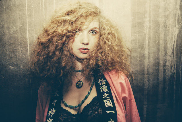 Woman curly hair red jacket free wallpaper - medium preview image