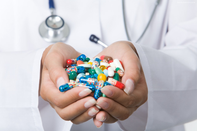 Doctor holding pills stethoscope white free wallpaper - medium preview image