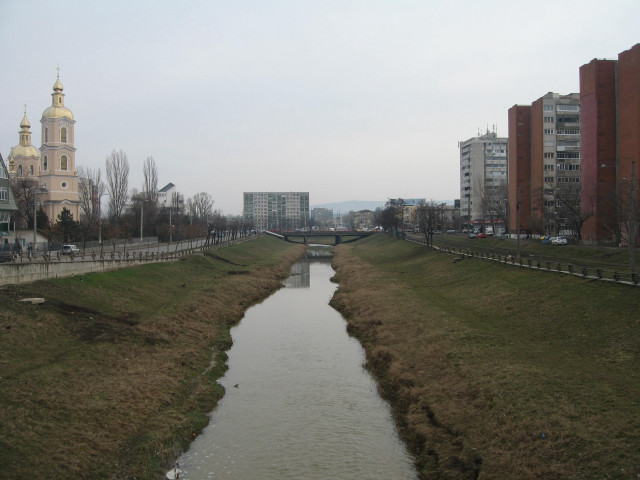 River lush field tall buildings free wallpaper - medium preview image