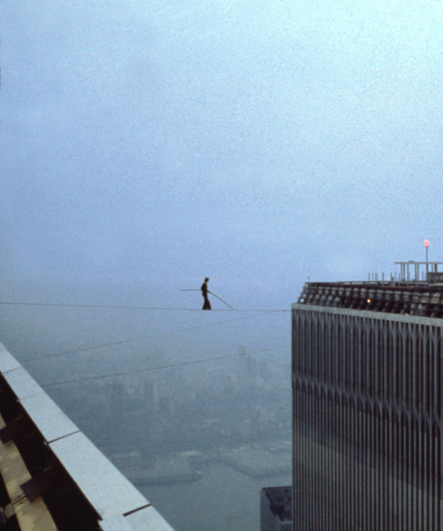 Man tightrope walking city skyline free wallpaper - medium preview image