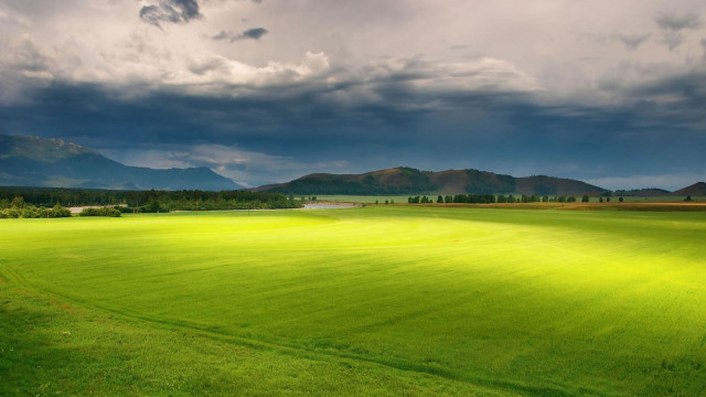 Green grass field mountains clouds free wallpaper - medium preview image