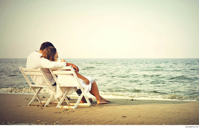 Couple sitting beach ocean looking free wallpaper - medium preview image