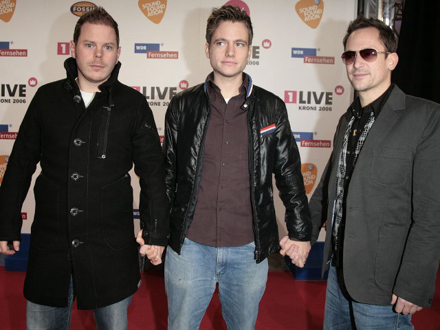Three men holding hands red free wallpaper - medium preview image
