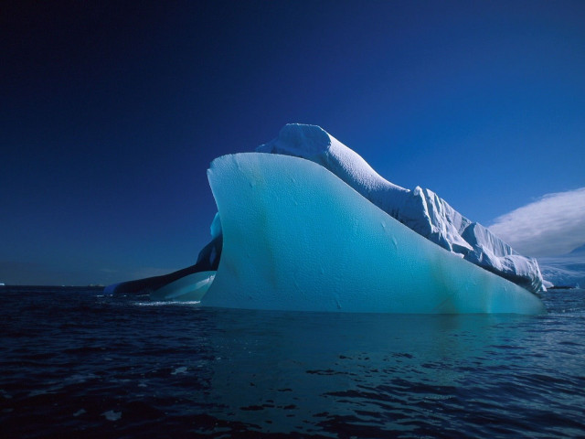 Iceberg floating ocean sky clouds free wallpaper - medium preview image
