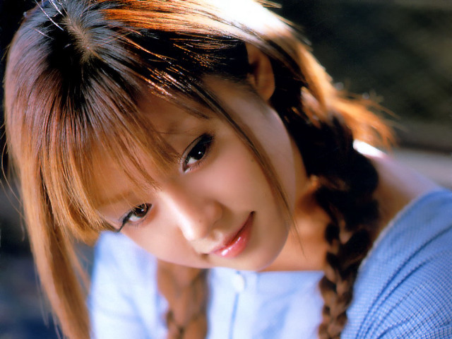 Young woman braid smiling camera free wallpaper - medium preview image