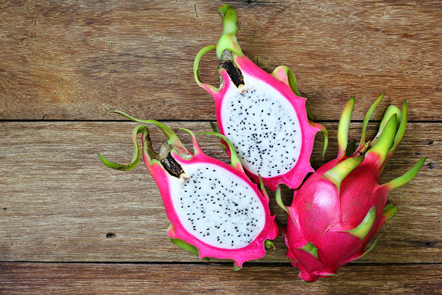 Dragon fruit halves wooden table free wallpaper - medium preview image