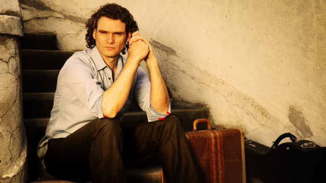 Man sitting stairs suitcase handbag free wallpaper - medium preview image