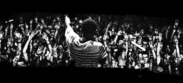 Man standing crowd stage arms free wallpaper - medium preview image