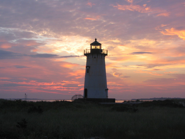 Lighthouse sunset silhouette clouds grassy free wallpaper - medium preview image