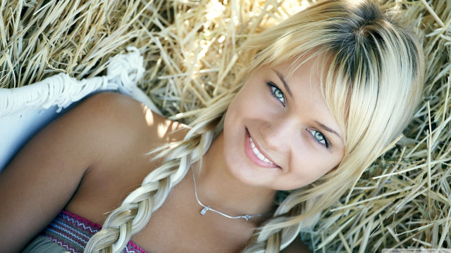 Blond woman hay pile smile free wallpaper - medium preview image