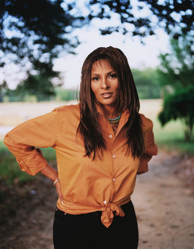 Woman standing dirt road hands free wallpaper - medium preview image
