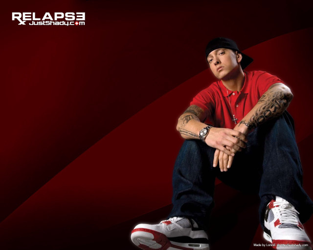 Tattooed man sitting red background free wallpaper - medium preview image