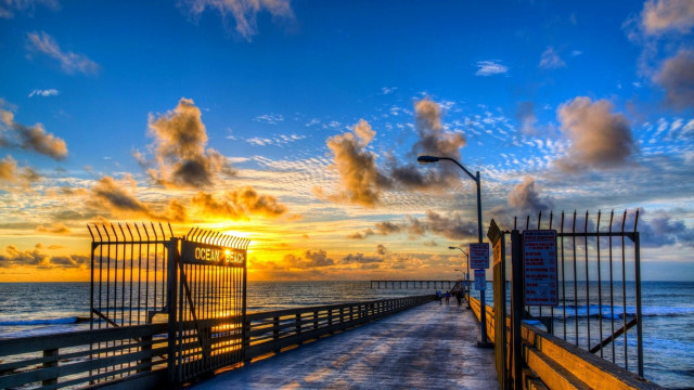 Pier fence sunset ocean cityscape free wallpaper - medium preview image