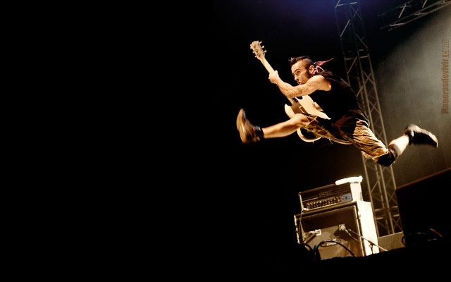 Man jumping stage guitar microphone free wallpaper - medium preview image