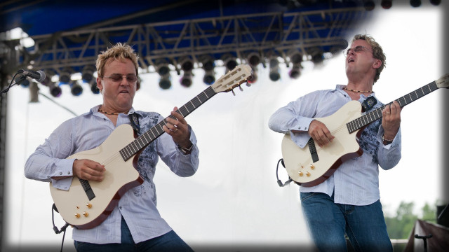 Two men playing guitars stage free wallpaper - medium preview image