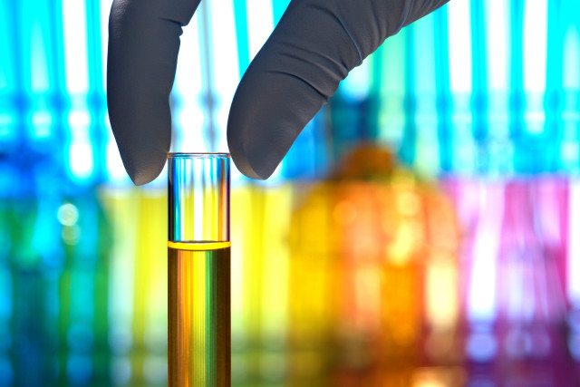 Gloved hand test tube liquid free wallpaper - medium preview image