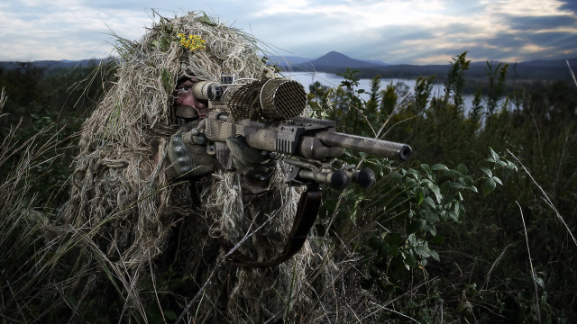 Man gun field grass mountain free wallpaper - medium preview image