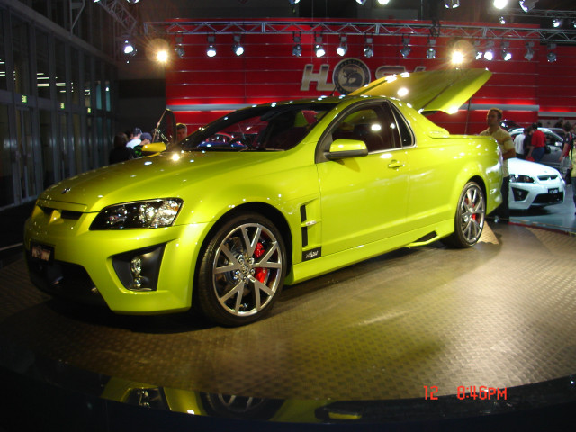 Yellow car showroom display people free wallpaper - medium preview image