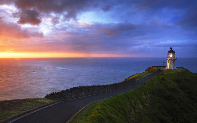 Lighthouse hill ocean sunset cloudy free wallpaper - medium preview image
