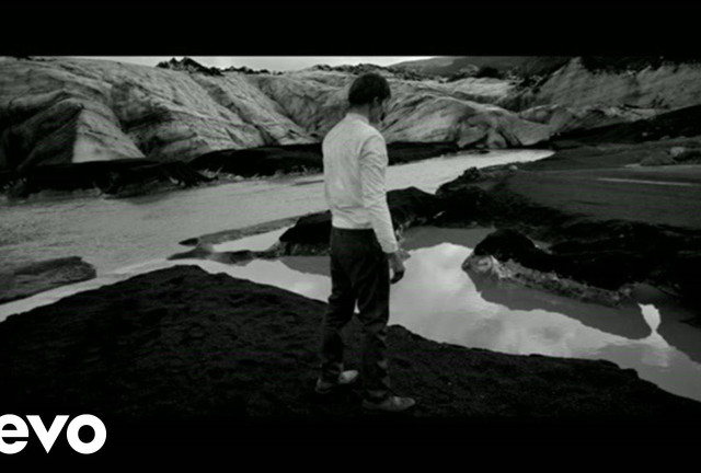 Man standing rocky hillside river free wallpaper - medium preview image