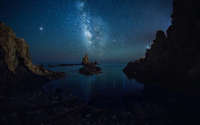 Night sky starry water rocks free wallpaper - medium preview image