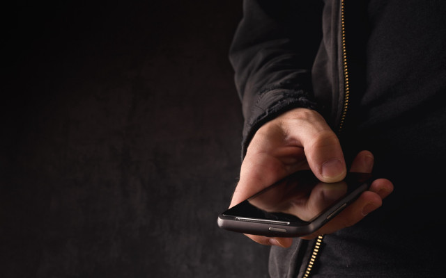 Person holding cellphone pointing dark free wallpaper - medium preview image