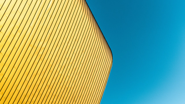 Yellow building blue sky plane free wallpaper - medium preview image