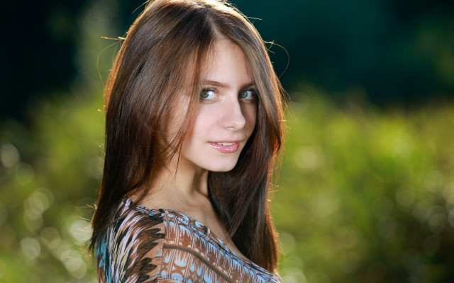 Woman longhair blueshirt bushbackground portrait free wallpaper - medium preview image