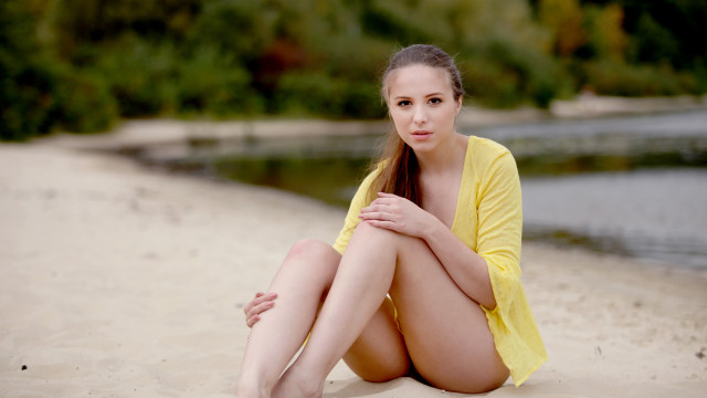 Beach woman crossedlegs hand on free wallpaper - medium preview image