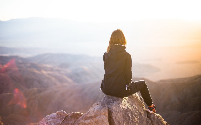 Woman sitting valley mountains sunset free wallpaper - medium preview image