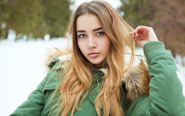 Woman green jacket snow portrait free wallpaper - medium preview image