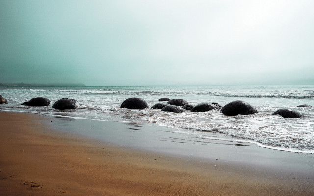 Beach rocks sand ocean cloudy free wallpaper - medium preview image