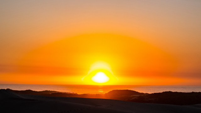 Sunset ocean beach people mountains free wallpaper - medium preview image