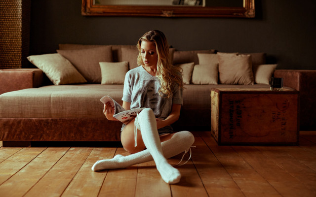 Woman sitting crossed remote couch free wallpaper - medium preview image