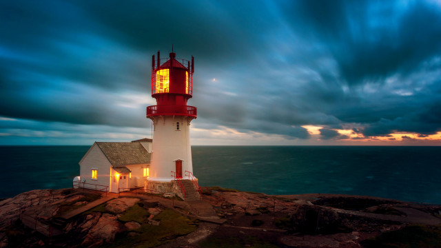 Lighthouse rocky outcropping cloudy sky free wallpaper - medium preview image