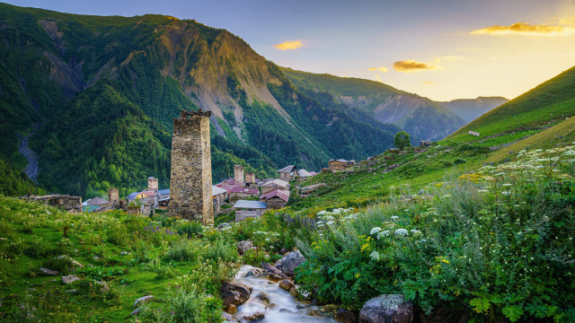 Lush hillside stream tower cloudscape free wallpaper - medium preview image