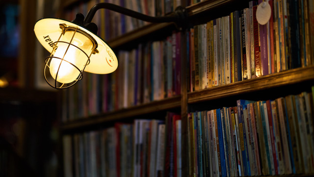 Lit lamp library bookshelf blurry free wallpaper - medium preview image